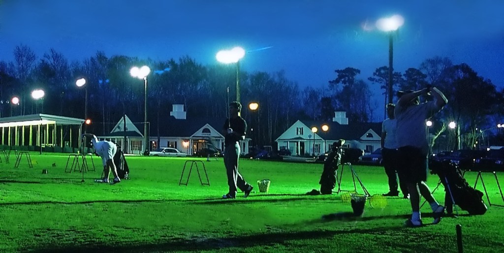 players at the driving range after dark